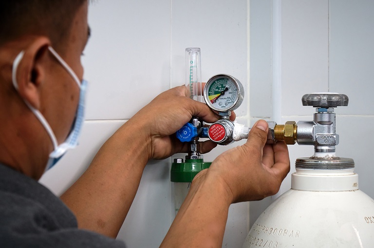 Staff checking the oxygen regulator